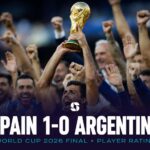 A Spain player lifts the World Cup 2026 trophy after victory over Argentina in the final.