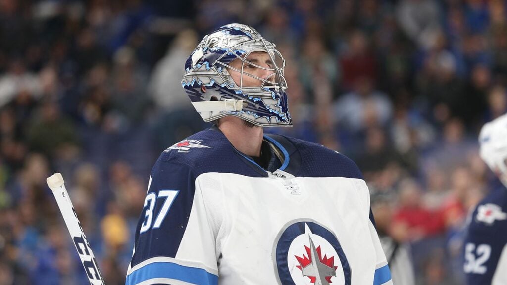 Winnipeg Jets goaltender Connor Hellebuyck in his mask and No. 37 road jersey during a game
